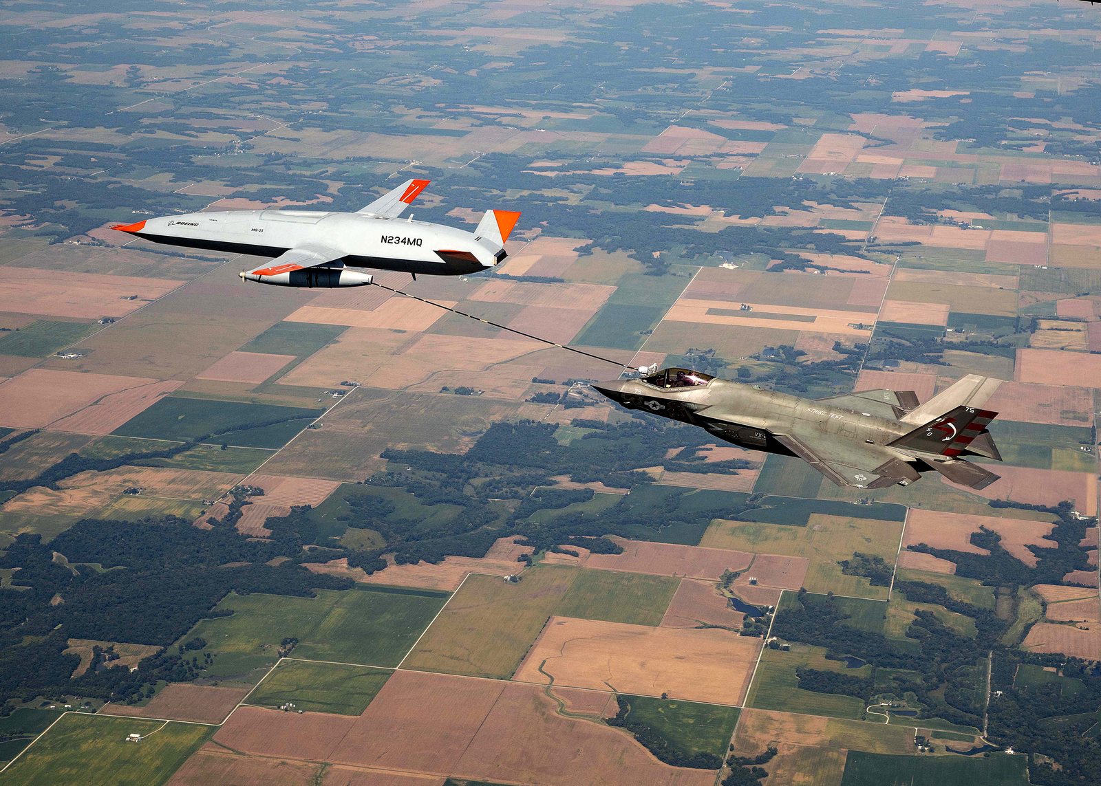 Unmanned Boeing MQ-25 Stingray test aircraft refuels a manned F-35C fighter in flight