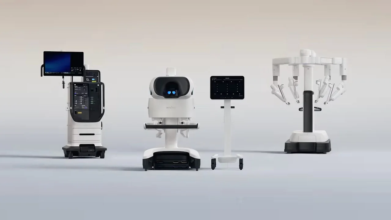 The da Vinci 5 surgical system shown as a coordinated lineup of surgeon console, vision cart and patient-side robot