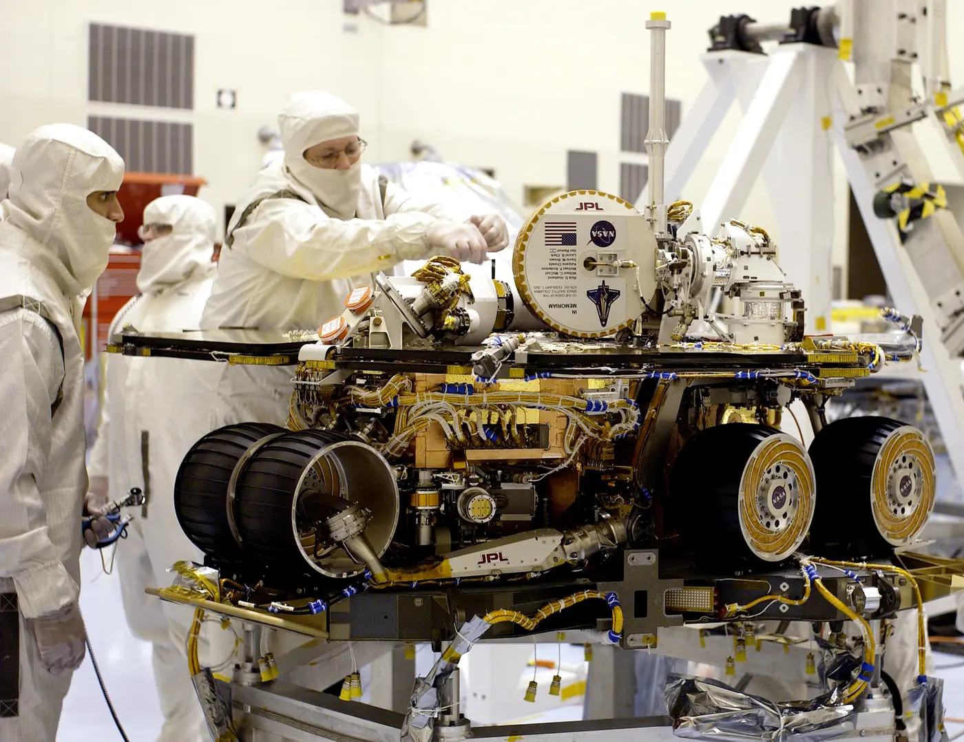 NASA photograph showing technicians completing final checks on the Spirit rover.