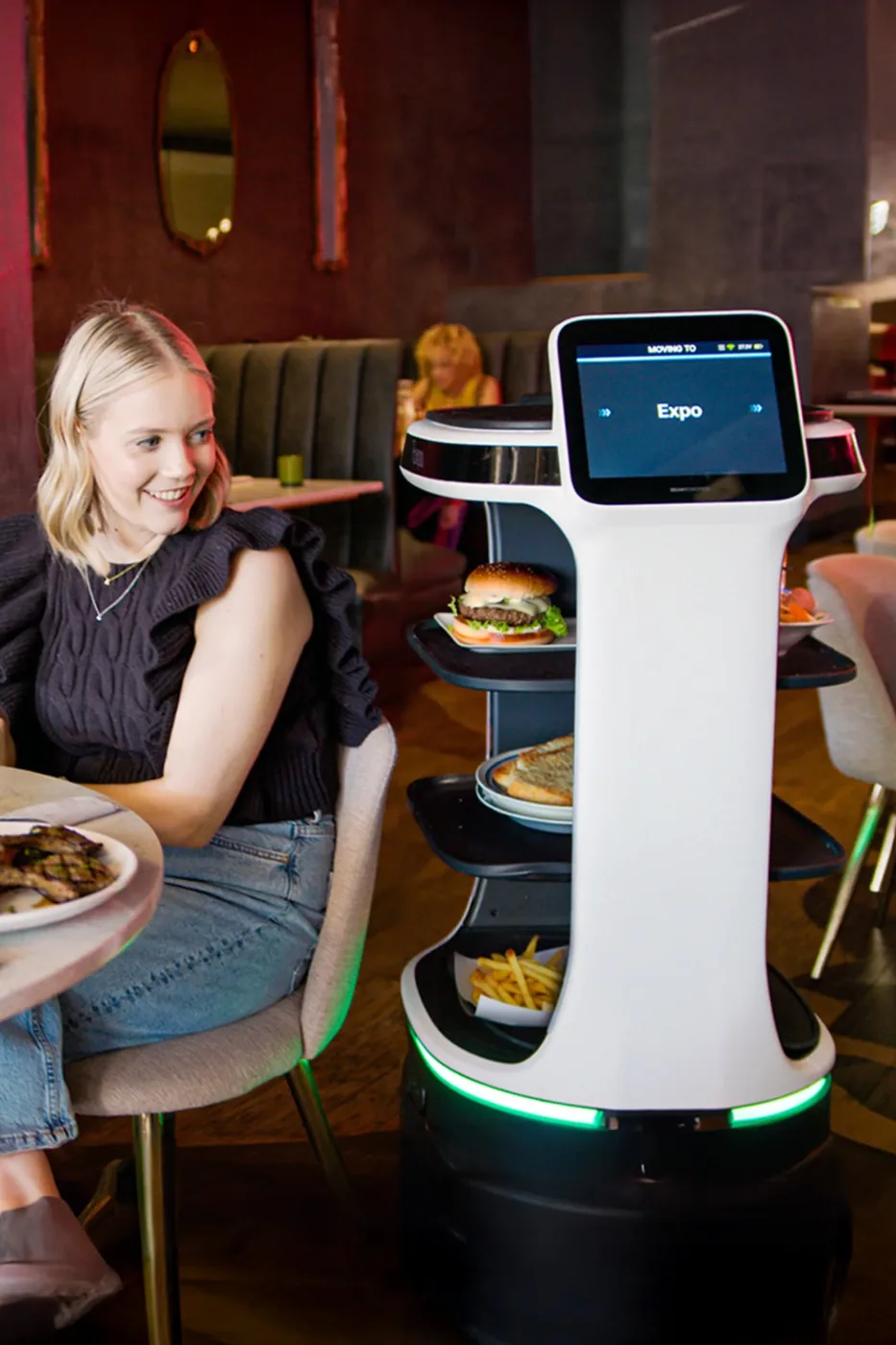 Bear Robotics Servi Plus carrying trays in a restaurant