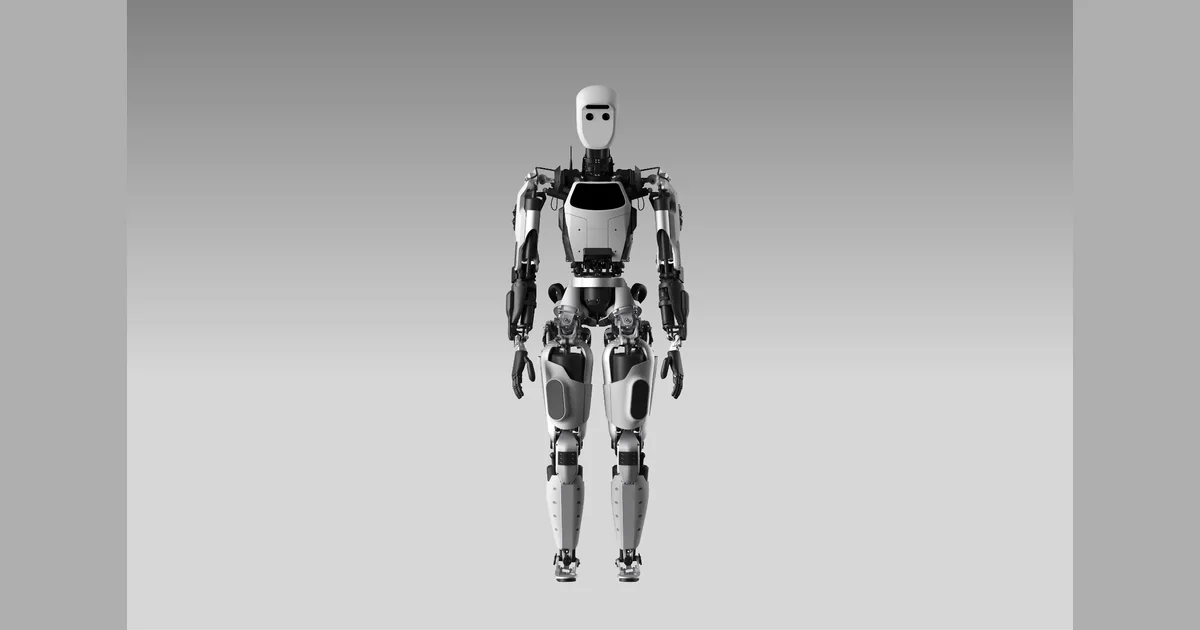 Full-body front view of Apptronik's black and white Apollo 1 humanoid robot against a gray studio background