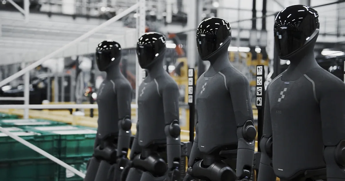 Four dark Figure 03 humanoid robots standing in a row on the BMW Group Plant Spartanburg factory floor