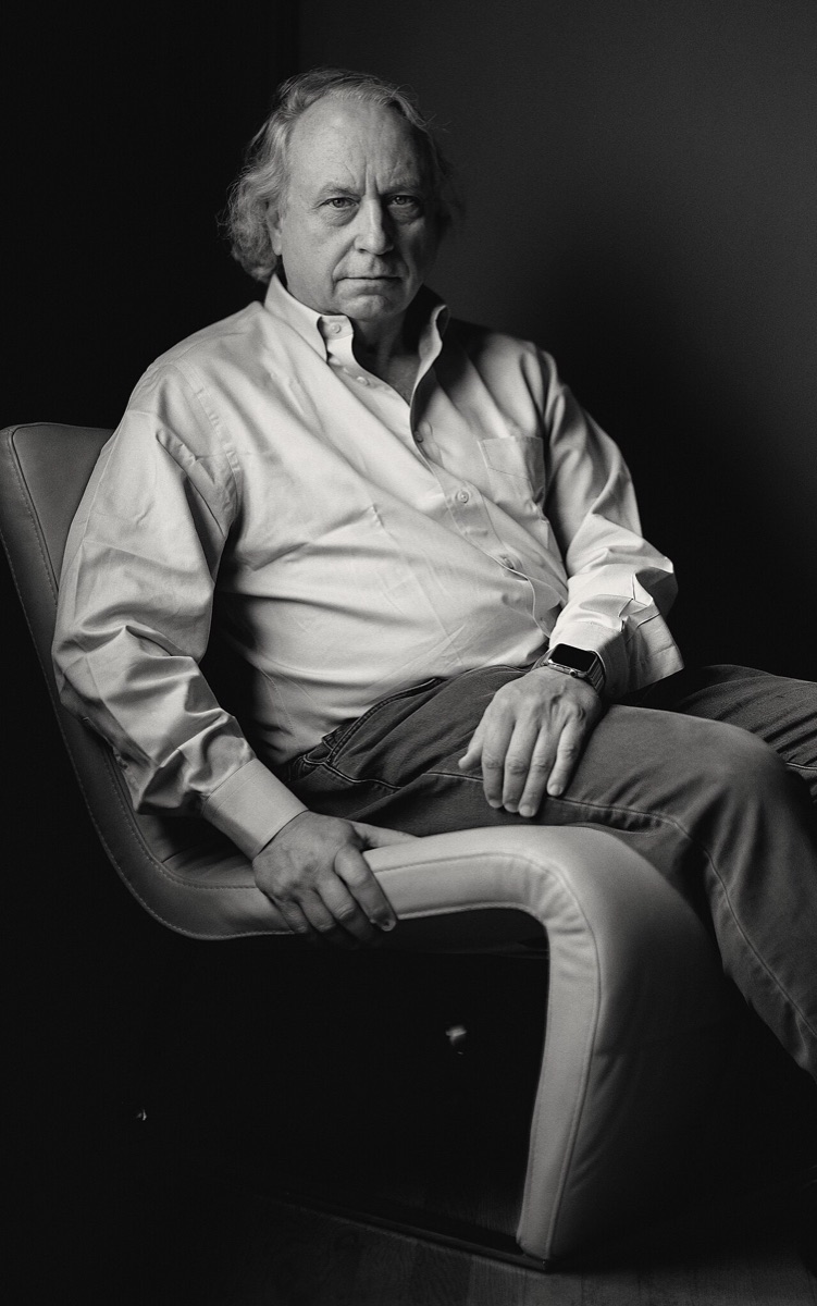 Black-and-white seated portrait of roboticist Rodney Brooks