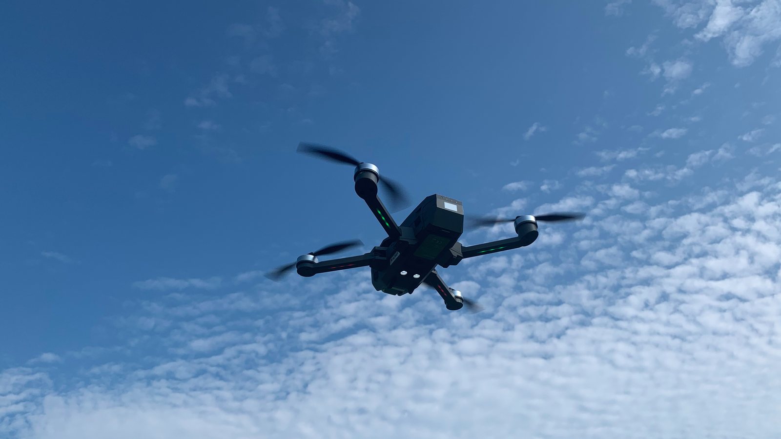 A small recreational quadcopter drone in flight