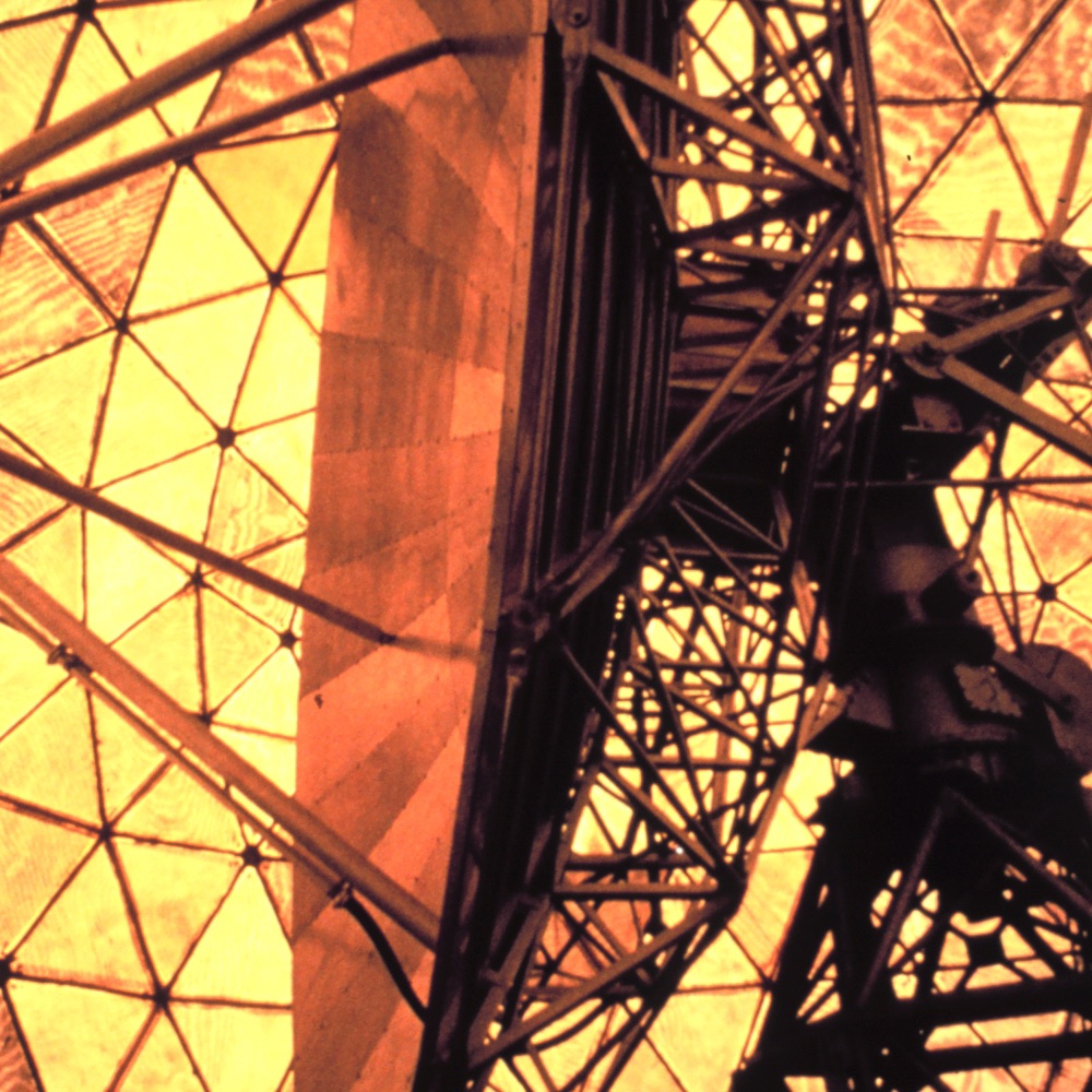 Research Doppler radar dish and support structure silhouetted inside a geometric radar dome